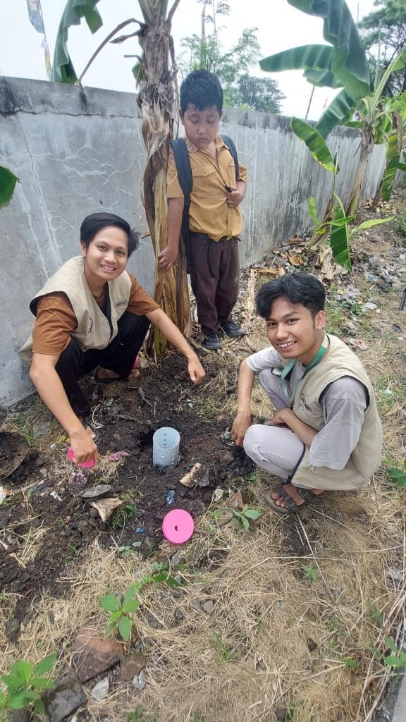 A group of people kneeling in the dirt Description automatically generated