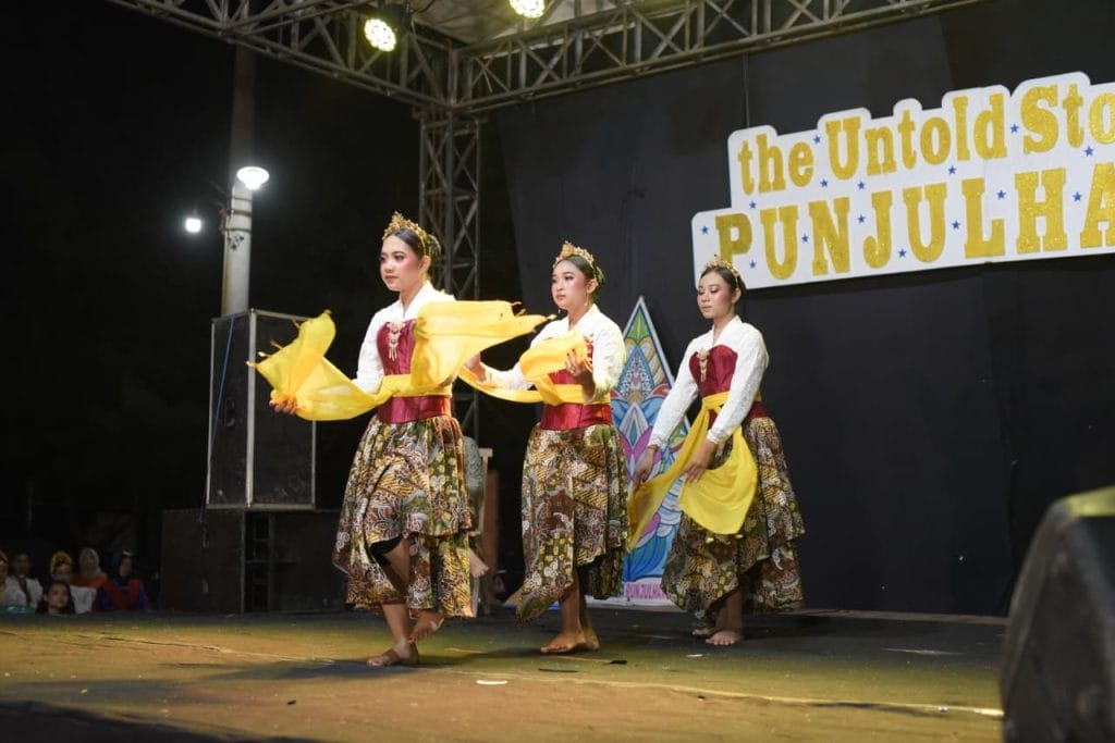 A group of women dancing on a stage AI-generated content may be incorrect.