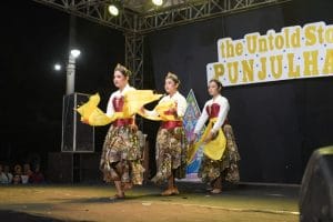 A group of women dancing on a stage AI-generated content may be incorrect.